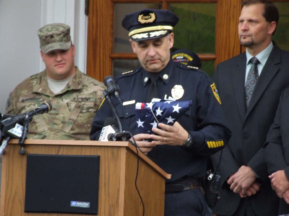Chief Michael Peraino accepting flag